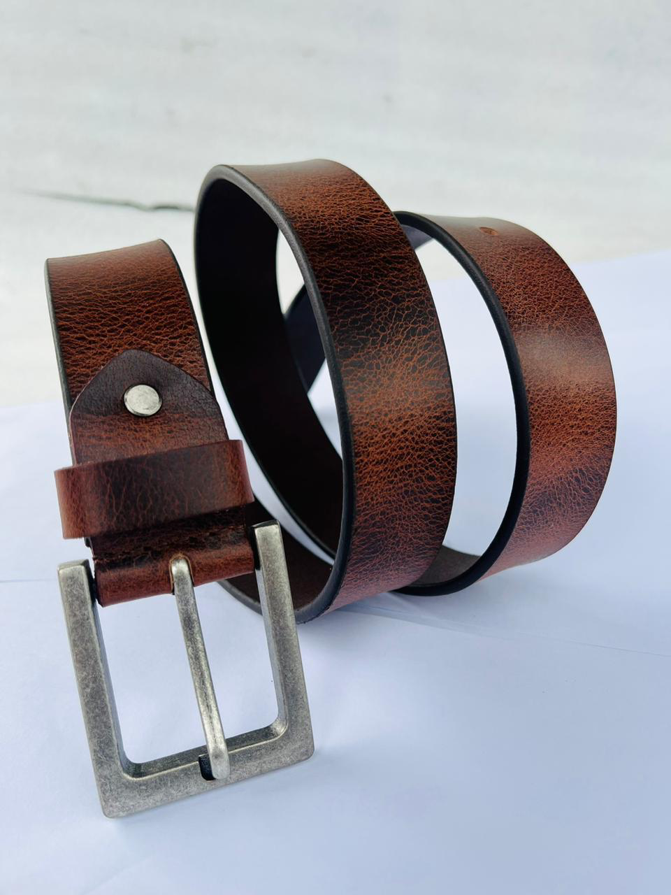 Brown leather belt with buckle